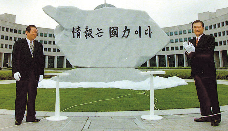 국가정보원이 대외안보정보원으로 명칭을 변경하고 국내 정치 참여가 엄격히 제한된다. 더불어민주당 조정식 정책위의장은 30일 이날 오전 국회에서 열린 고위 당·정·청 협의회에서 권력기관 개혁 후속 과제 논의를 통해 이같이 결정했다고 밝혔다. 사진은 1998년 5월 국가정보원으로 명칭이 바뀌기 전의 국가안전기획부 청사를 방문한 김대중 전 대통령(오른쪽)이 자신의 직접 쓴 ‘정보는 국력이다’원훈석 제막식을 마친 뒤 박수를 치고 있는 모습. 왼쪽은 이종찬 당시 안기부장. [연합]