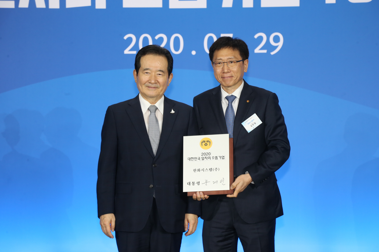 김연철 한화시스템 대표이사(사진 우측)가 정세균 국무총리로부터 '대한민국 일자리 으뜸기업' 인증패를 받은 후 기념촬영을 하고 있다. [한화시스템 제공]