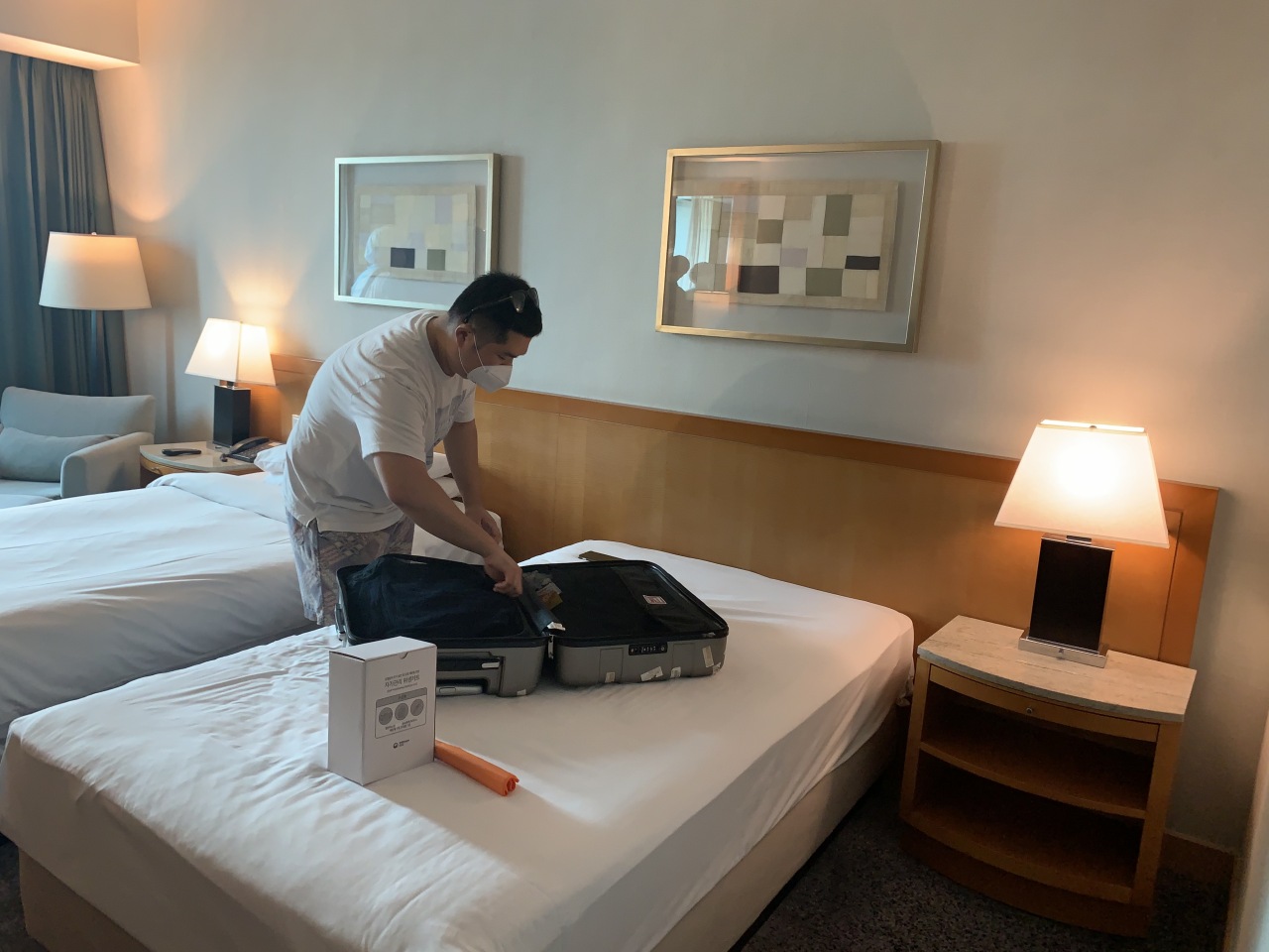 A passenger who checked in on Wednesday afternoon unpacks his belongings in the room where he will be staying for the next two weeks.