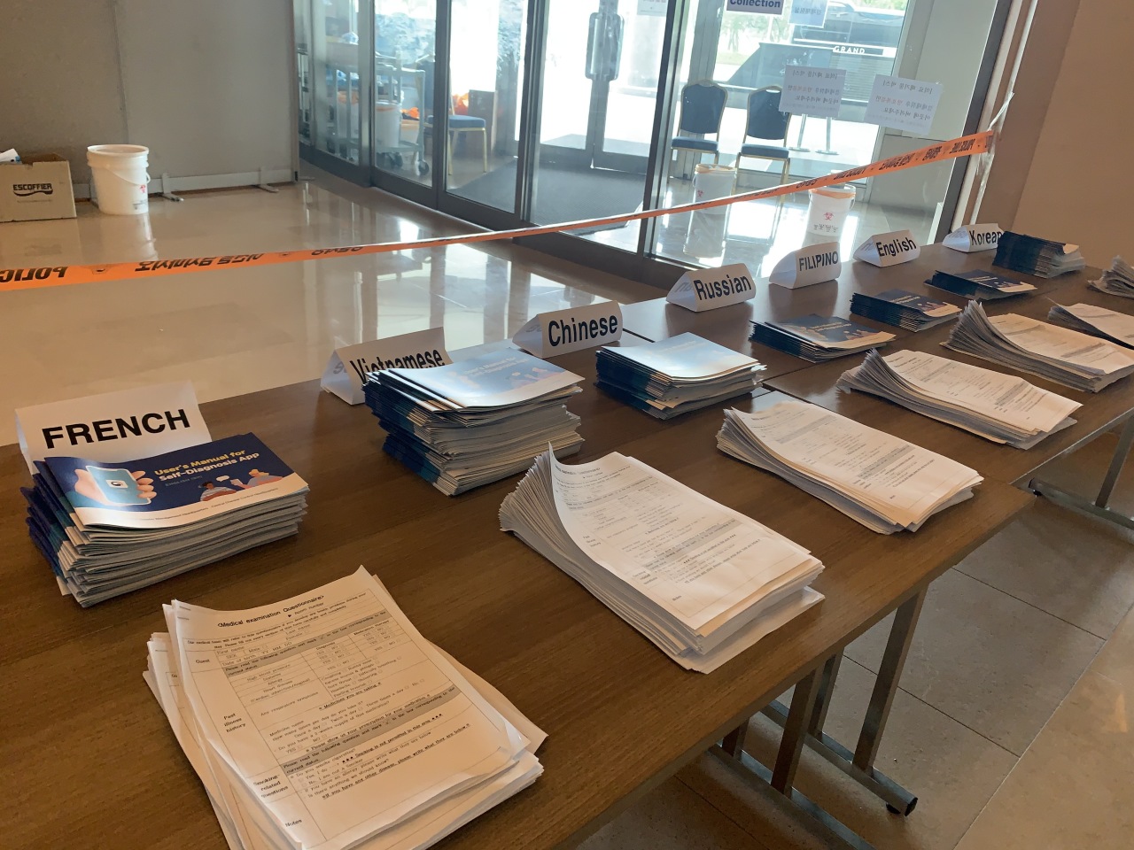 After having their samples collected for testing, passengers are required to fill out a medical questionnaire and install a health app for checking symptoms. Instructions are provided in seven languages.