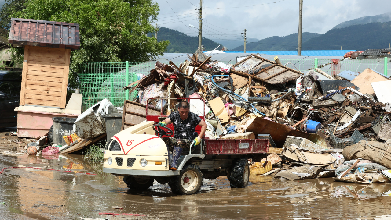 Recovery work is underway Wednesday in a village in Namwon, North Jeolla Province, which has been hit by flash floods triggered by recent torrential rains. (Yonhap)
