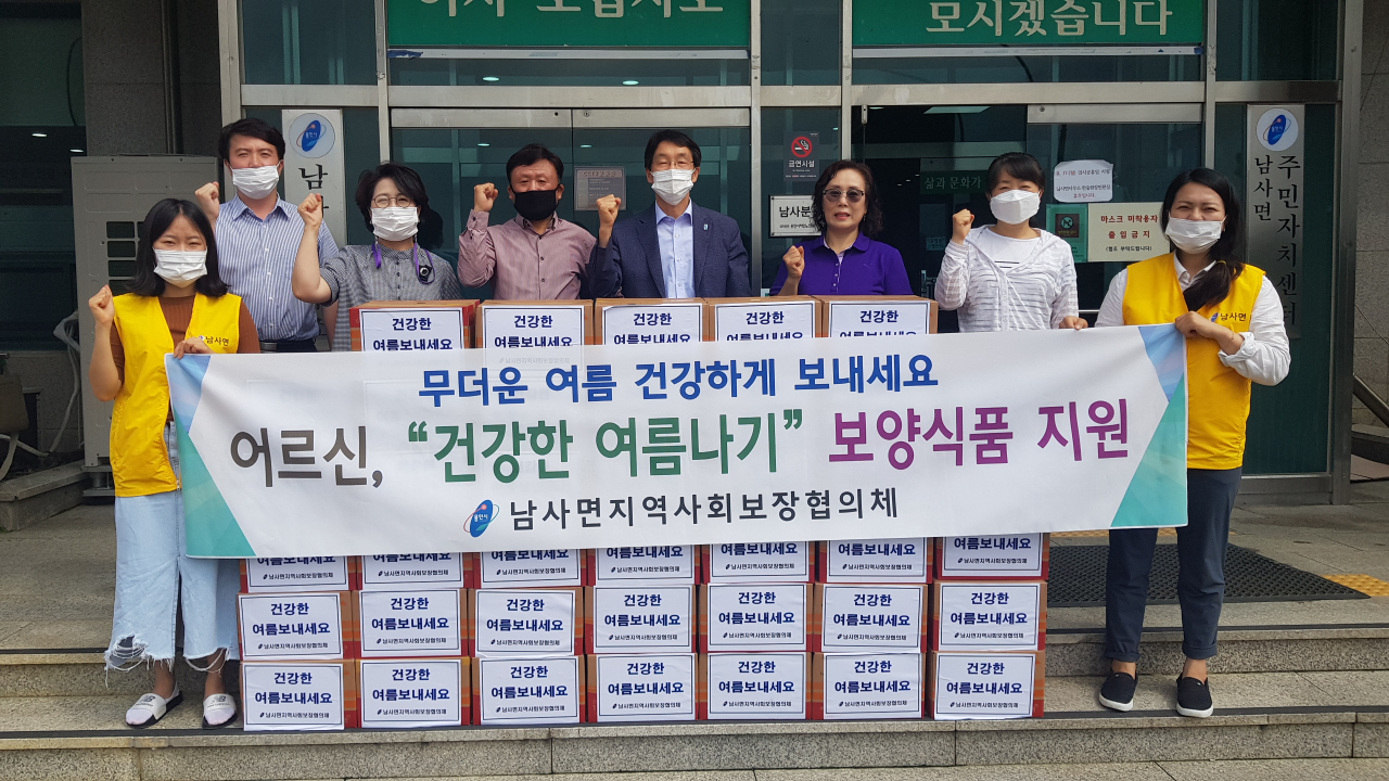 남사면 직원과 협의체 위원들이 보양식품 전달에 앞서 기념촬영을 하고 있다. [용인시 제공]