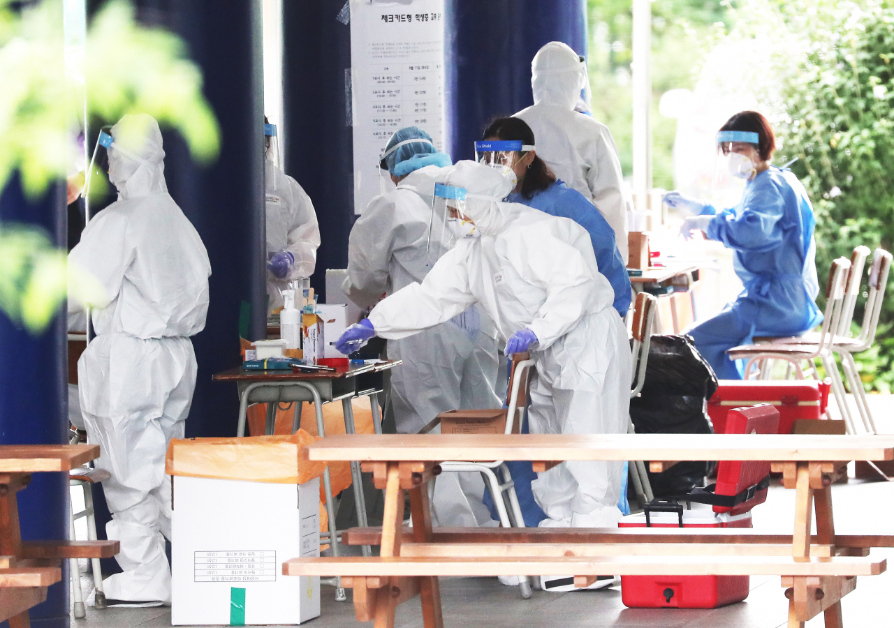 13일 오전 경기도 용인시 수지구 죽전고등학교에 설치된 선별진료소에서 학생 및 교직원을 대상으로 신종 코로나바이러스 감염증(코로나19) 전수검사가 진행되고 있다. [연합]