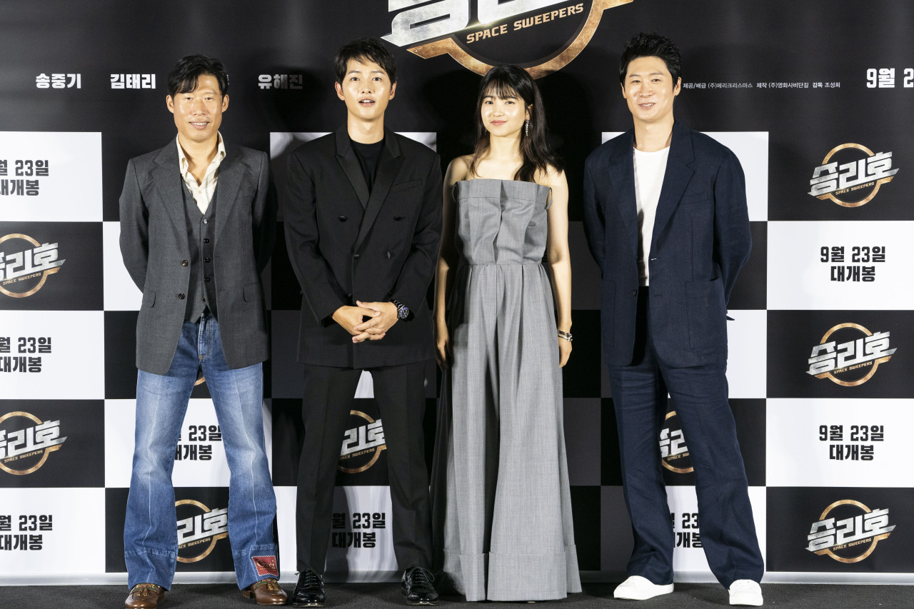 The cast of the film “Space Sweepers” -- (from left) Yoo Hai-jin, Song Joong-ki, Kim Tae-ri and Jin Seon-kyu -- pose for photos during an online press conference held Tuesday. (Merry Christmas)
