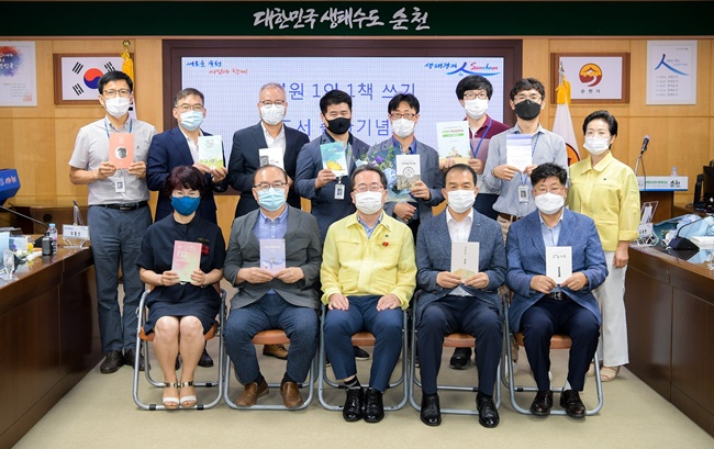 순천시 1인1책 쓰기 운동에 동참한 시청 공무원과 허석 시장(가운데)이 기념촬영하고 있다. [순천시 제공]
