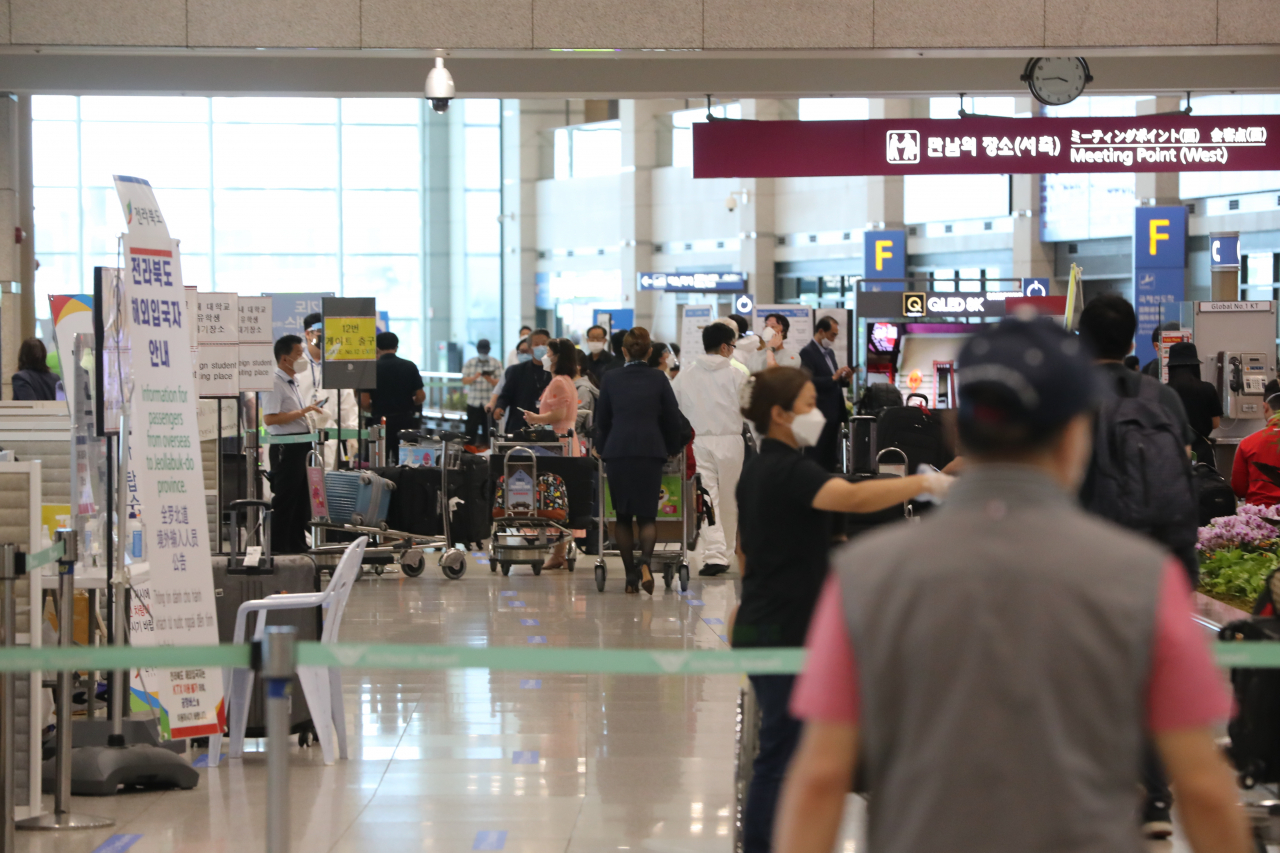 지난 16일 인천국제공항을 통해 귀국한 항공기 승객들이 지역별 격리를 위한 절차를 밟고 있다. [연합]