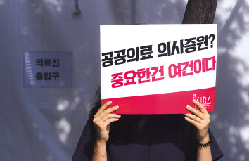 지난 25일 오전 서울 동작구 중앙대병원 앞에서 전공의들이 의대 정원 확대 등 의료 정책에 반대하는 피켓을 들고 있다. 박해묵 기자