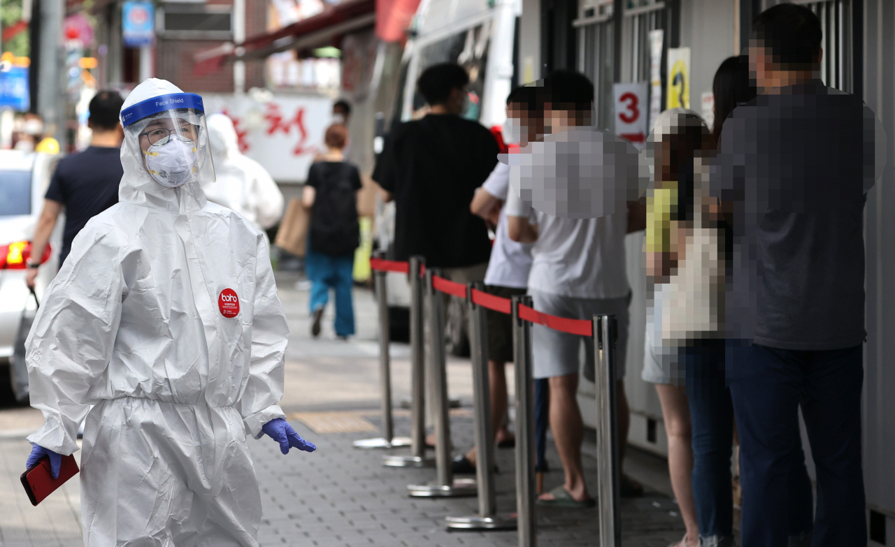 오전 서울 성북구보건소에 마련된 선별진료소에서 시민들이 검사를 받기 위해 줄을 서고 있다. [연합뉴스]