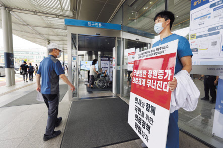 전공의 무기한 집단휴진 지속을 결정한 가운데 31일 오전 서울 종로구 서울대학교병원에서 해당 병원 전문의가 정부의 의료정책에 반대하는 1인 시위를 하고 있다. [연합]