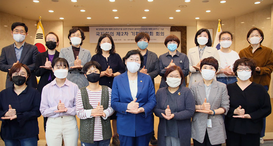 이정옥 여성가족부 장관이 지난 5월8일 서울 광화문 정부서울청사에서 열린 ‘북경행동강령 채택 25주년 및 유엔 안보리 결의안 1325호 채택 20주년 기념 국제회의’ 제2차 기획위원회 회의에 앞서 위원들과 ‘덕분에 챌린지’ 수어 동작을 하고 있는 모습.