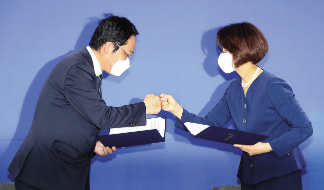 한정애(오른쪽) 더불어민주당 정책위의장과 최대집 대한의사협회장이 4일 오전 서울 여의도 민주당사에서 정책협약 이행 합의서에 사인 후 주먹을 맞대고 있다. 민주당과 의협 간 합의안에는 의료계에서 파업 철회 조건으로 내걸어온 “의대 정원 확대, 공공의대 신설 추진 등을 원점에서 재검토한다”는 내용이 담겼다. 이상섭 기자