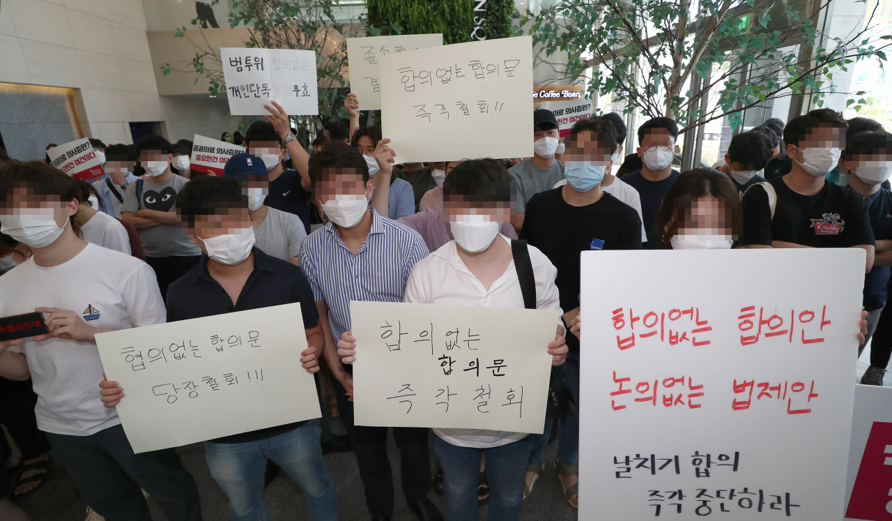 전공의들이 4일 오후 서울 중구 한국증진개발원에서 열리는 '의대정원 원점 재논의 정책협약 이행합의서 체결 협약식'을 막기 위해 로비에 모여 있다. [연합]