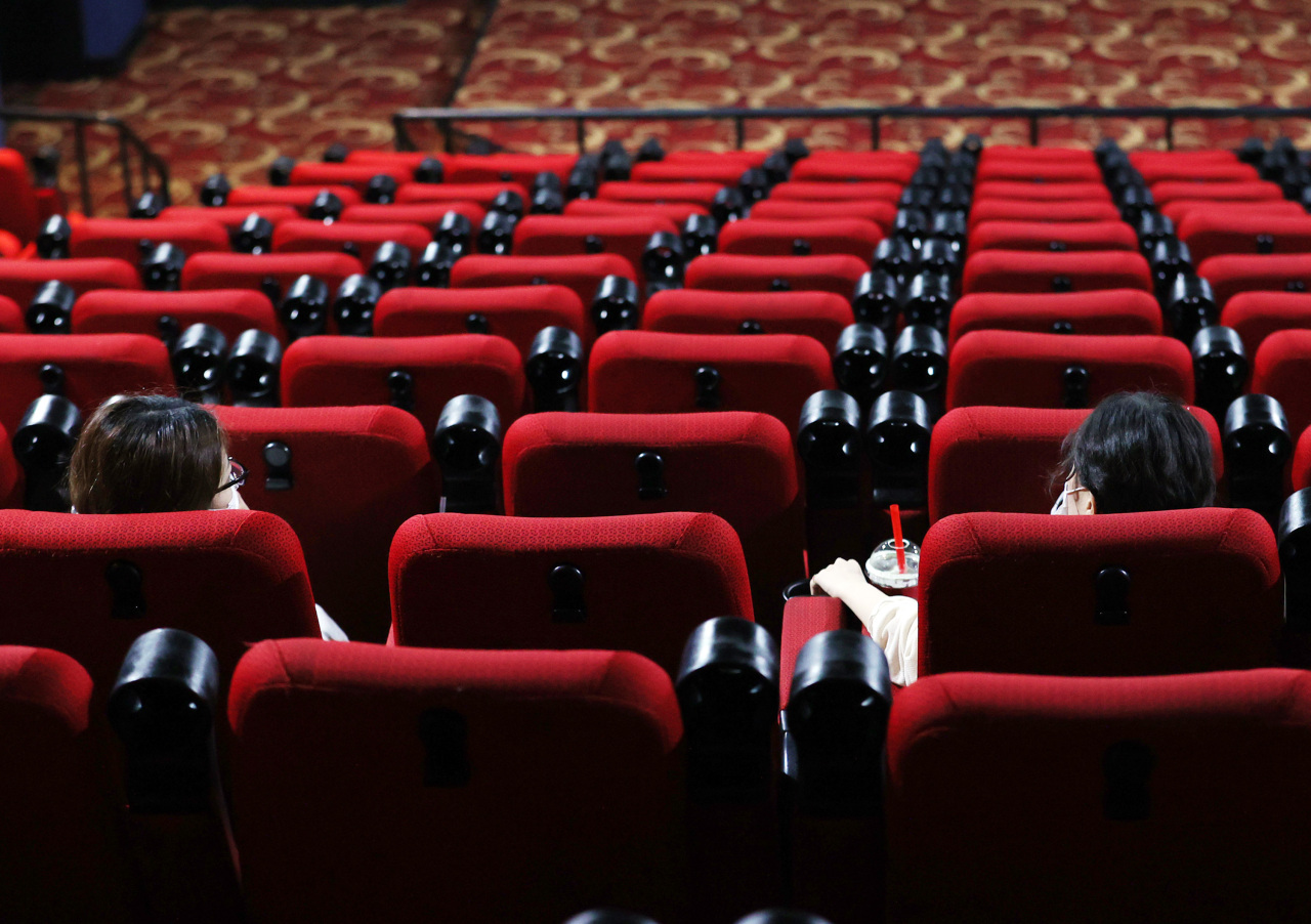 Two people are seated apart in a local cinema in Seoul on Aug. 26 in compliance with social distancing measures. (Yonhap)