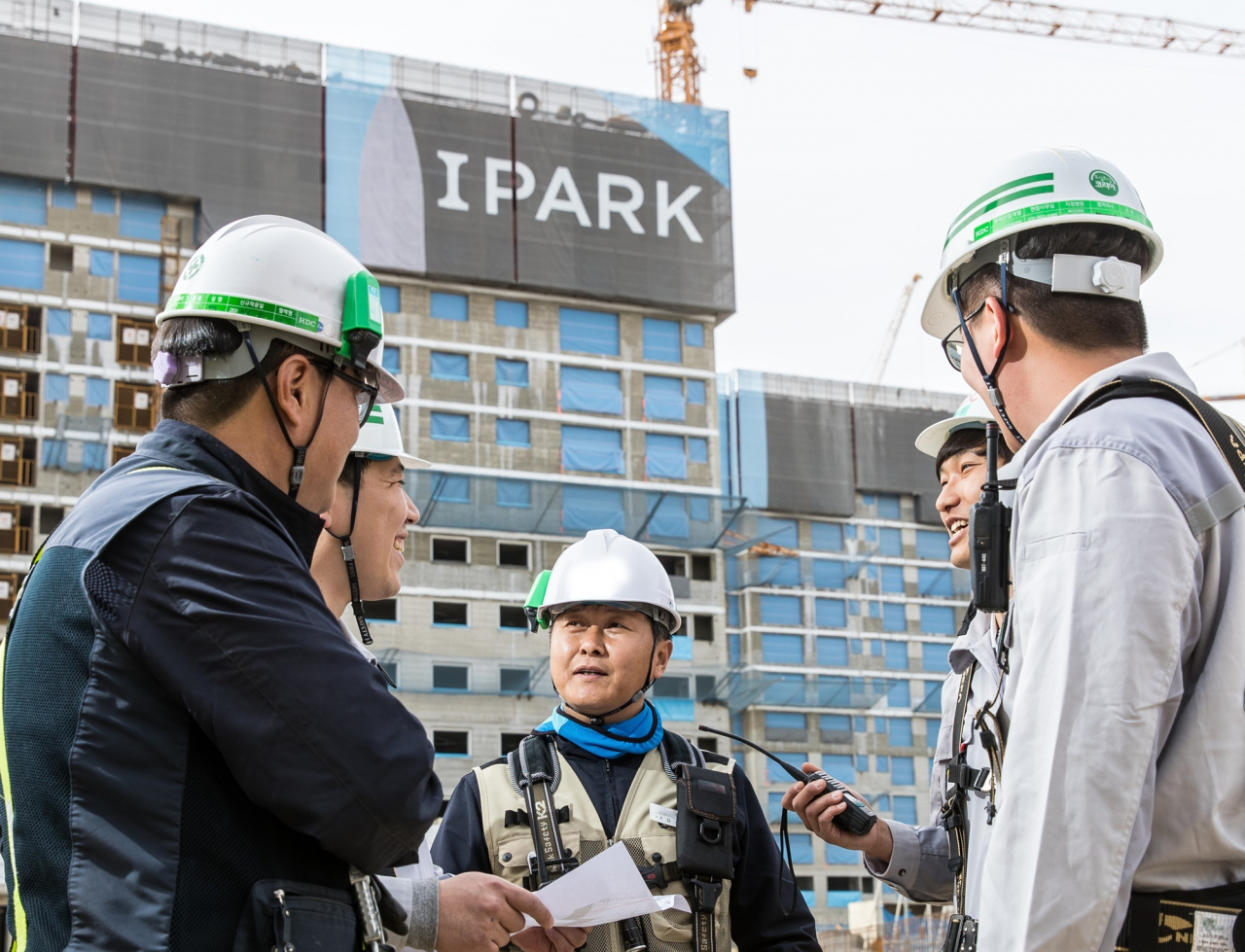 HDC현대산업개발 직원과 협력사 직원들이 지난해 명절을 앞두고 IPARK 공사 현장에서 대화를 나누고 있다. [HDC현대산업개발 제공]