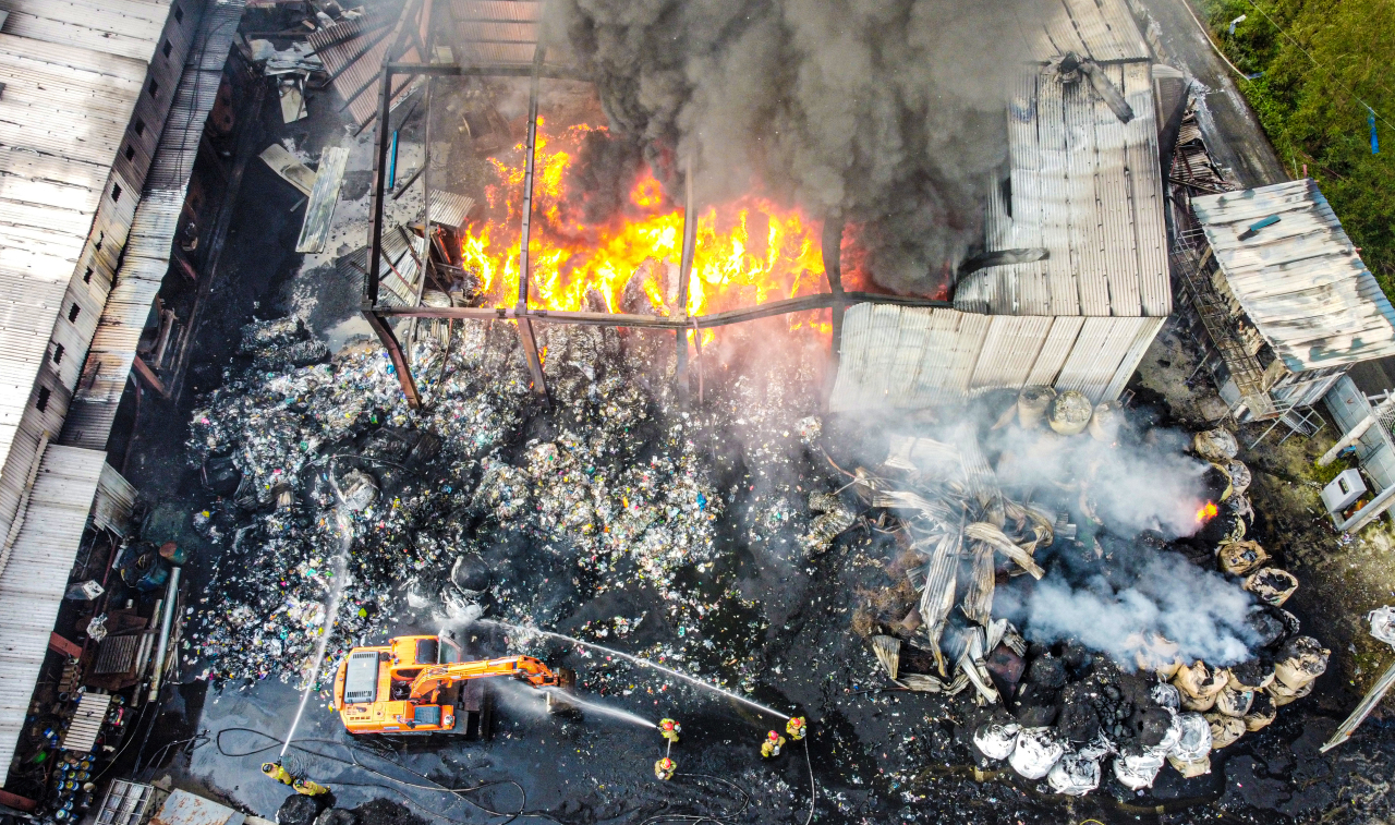 Firefighters put out a fire at a plastic waste recycling company in Pyeongtaek, south of Seoul, on Saturday. Two foreign workers were killed in the blaze. (Yonhap)