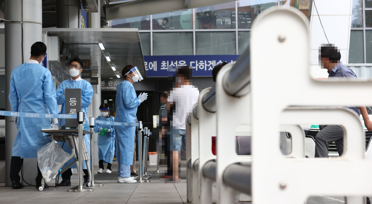Medical staff and health officials talk to visitors at a treatment booth stationed at Yonsei Severance Hospital in Seoul on Thursday. (Yonhap)