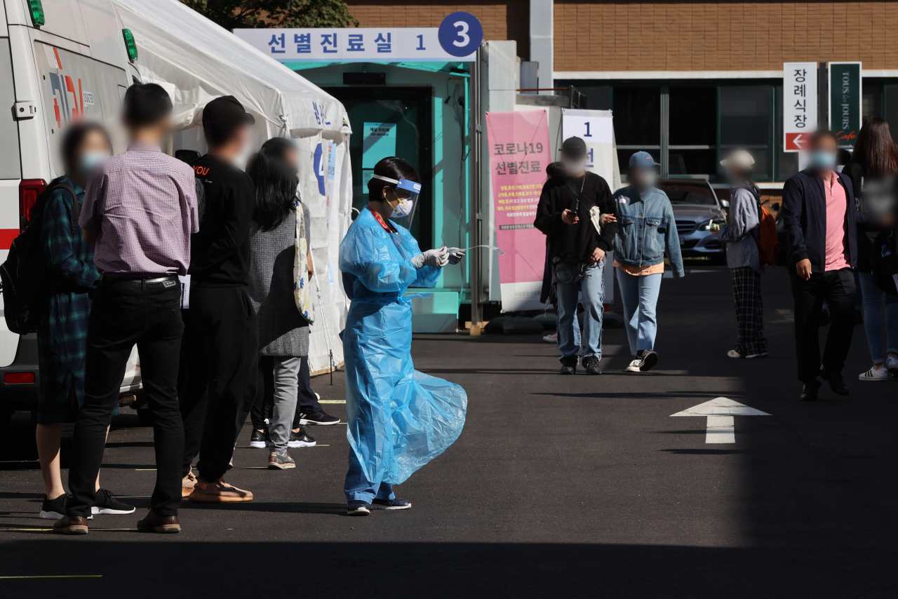 신종 코로나바이러스 감염증(코로나19) 신규 확진자 수가 사흘 연속 두 자릿수를 유지한 22일 서울 중구 국립중앙의료원 선별진료소에서 시민들이 검사 순서를 기다리고 있다. [연합]