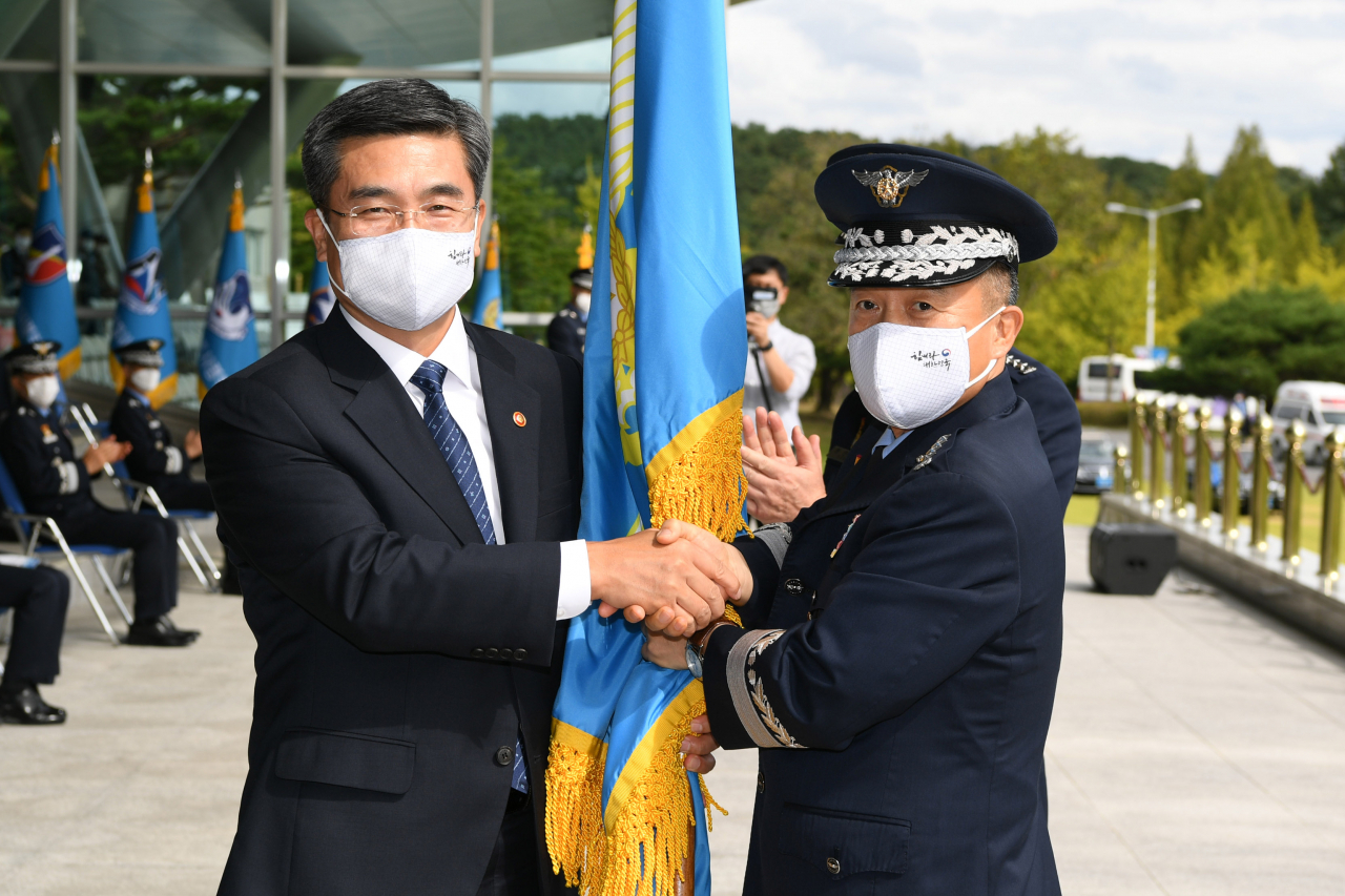 이성용 공군참모총장(오른쪽)이 23일 충남 계룡대 대연병장에서 거행된 '제37·38대 공군참모총장 이·취임식'에서 서욱 국방부 장관으로부터 지휘권을 상징하는 공군기를 전달받고 있다.[사진=공군]
