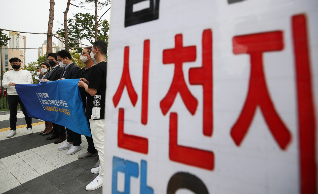 대구 소상공인 신천지 코로나 보상청구 소송인단이 지난 17일 오후 경기도 수원시 영통구 수원지방법원 앞에서 기자회견을 하고 있다.[연합뉴스]