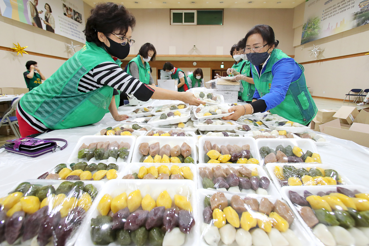 서울 성동구 새마을부녀회가 추석을 앞둔 지난 28일 성동구청 대강당에서 ‘사랑의 송편나누기’ 행사를 열었다. 사진은 성동구 새마을부녀회원들이 어르신에게 전달할 송편 을 포장하는 모습. [성동구 제공]