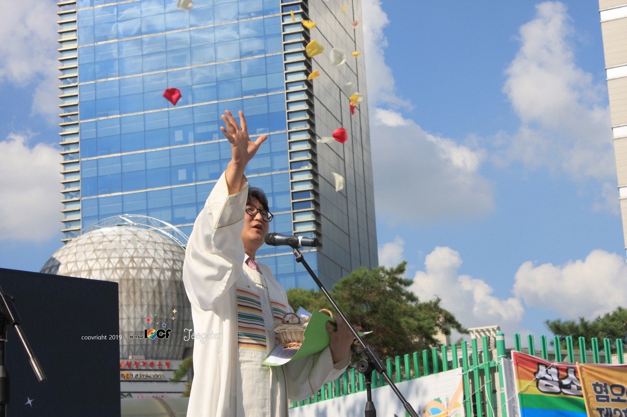Rev. Lee Dong-hwan sprinkles flower petals as he gives a blessing to sexual minorities during the Queer Culture Festival held in Incheon last year. (Jupiter)