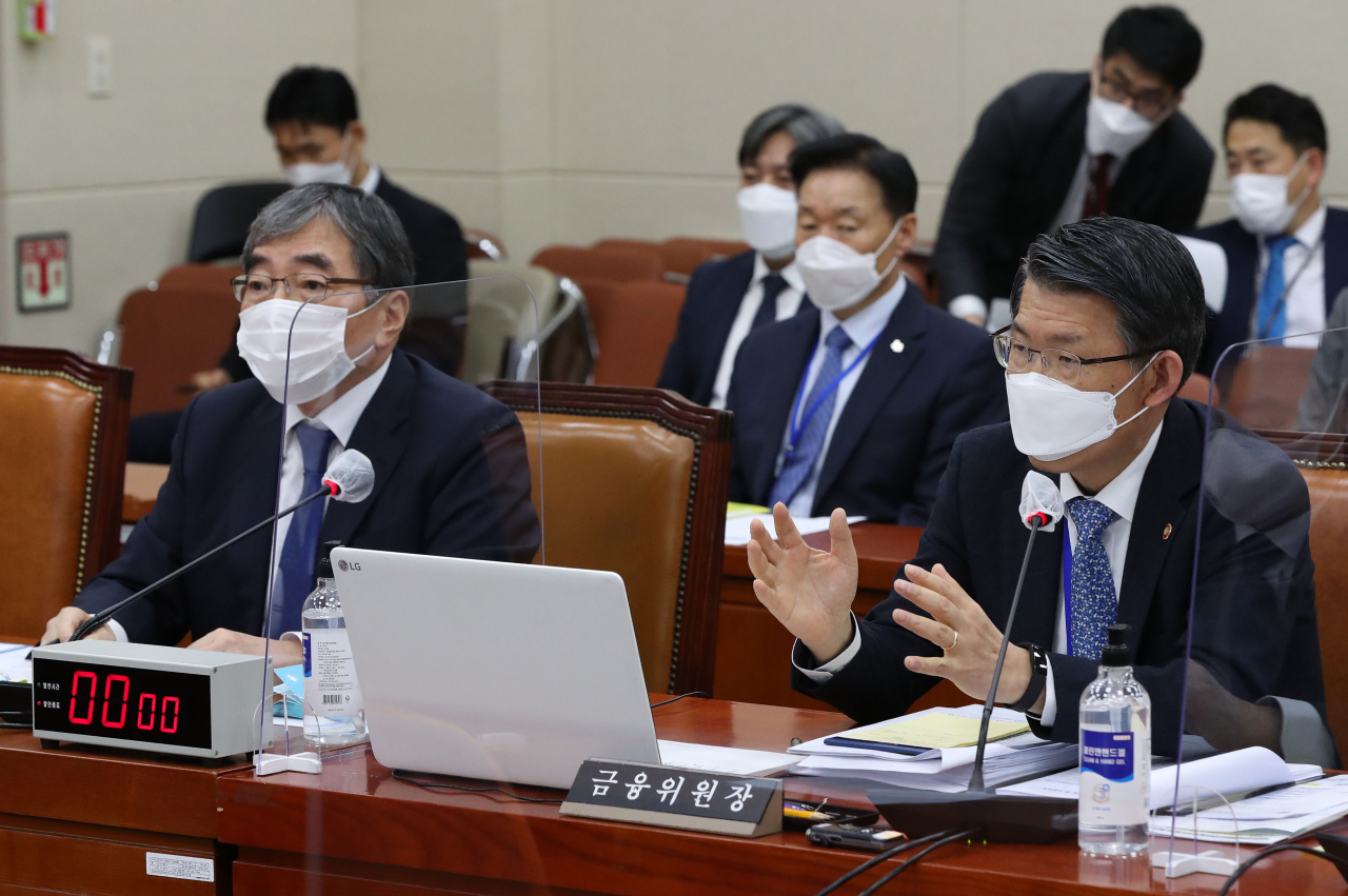 은성수 금융위원장(오른쪽)과 윤석헌 금융감독원장(왼쪽)이 23일 국회 정무위원회 종합감사에서 답변하고 있다. 은 위원장과 윤 원장은 지주회장 연임 문제, 금융위-금감원 갈등 문제 등에 대해 서로 다른 의견을 개진해 눈길을 끌었다. [연합]