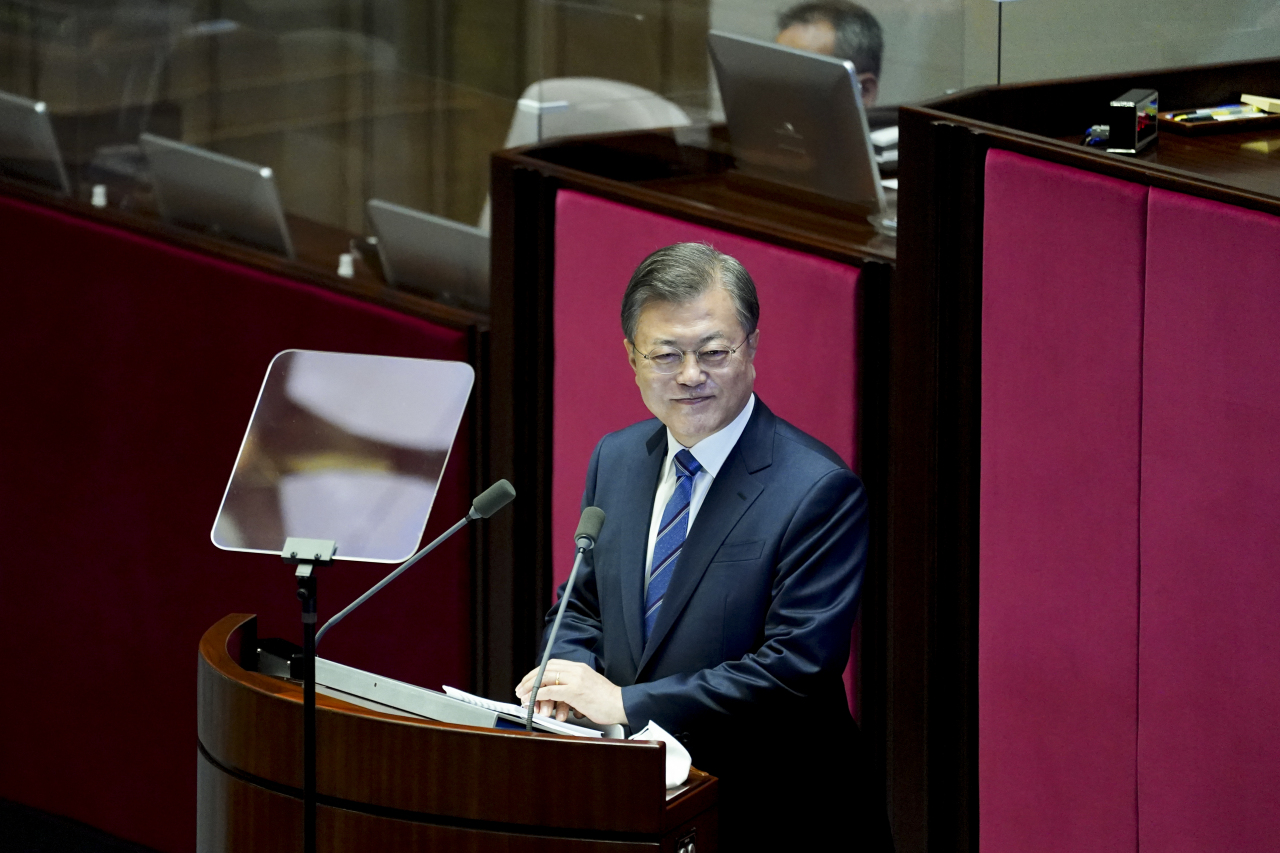 President Moon Jae-in looks at protesting opposition lawmakers during his parliamentary address on Wednesday. Yonhap