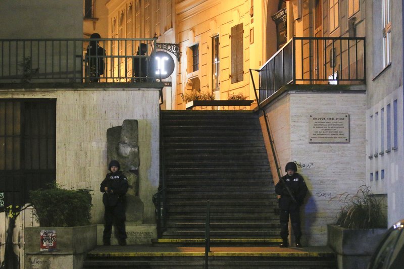 Police officers stay in position at stairs named 'Theodor Herzl Stiege' near a synagogue after gunshots were heard in Vienna, Monday. (AP-Yonhap)