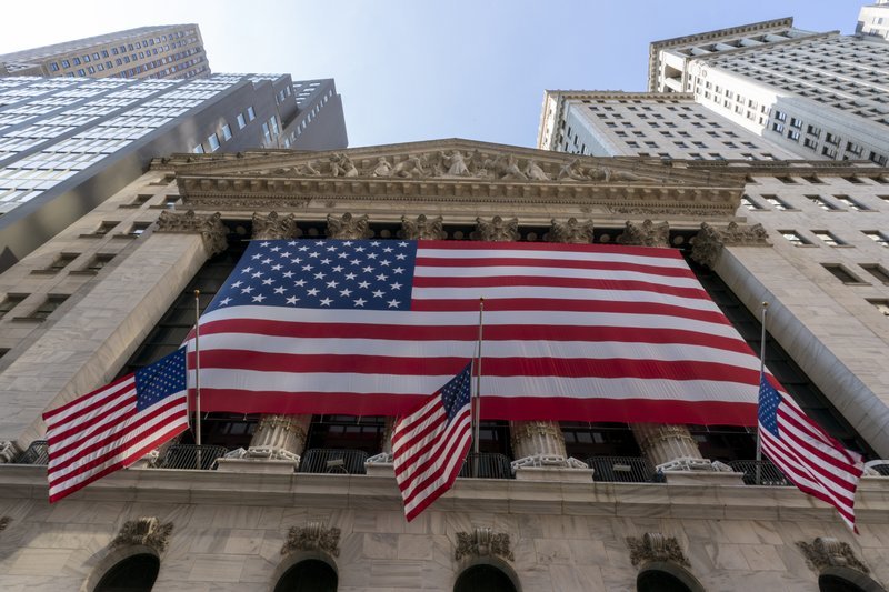 In this Monday file photo, a giant American Flag hangs on the New York Stock Exchange. US stocks are climbing Monday, kicking off a potentially turbulent stretch for markets, as Wall Street recovers some of its sharp sell-off from last week. (AP-Yonhap)