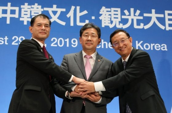 지난 해 8월 11회 한중일문화콘텐츠포럼에서 손을 맞잡은 한중일 3국. 사진 왼쪽부터 시바야마 마사히코 문부과학대신, 박양우 문화체육관광부 장관, 뤄수강 문화여유부 부장 [문체부 제공]