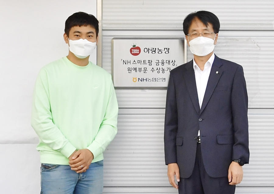 　12일 전북 김제시 하랑농장에서 손병환 농협은행장(오른쪽)과 허정수 하랑농장 대표가 ‘NH 스마트팜 금융대상’ 현판식을 진행하고 기념촬영을 하고 있다. [농협은행 제공]
