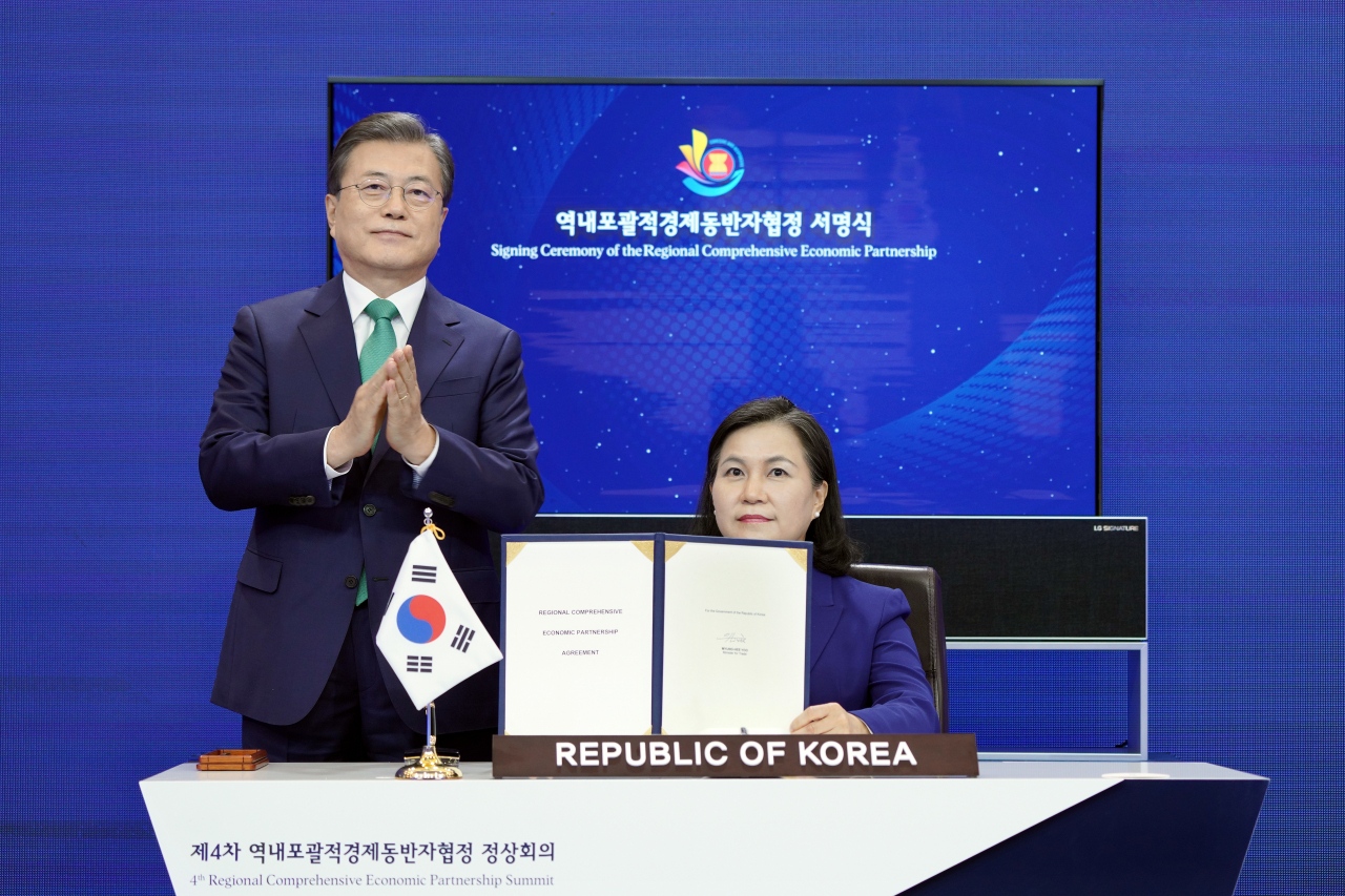 문재인 대통령이 지난 15일 청와대에서 열린 세계 최대규모의 자유무역협정(FTA)인 '역내포괄적경제동반자협정(RCEP)' 협정문 서명식에 참석, 유명희 통상교섭본부장이 협정문에 서명하자 박수치고 있다. [연합]