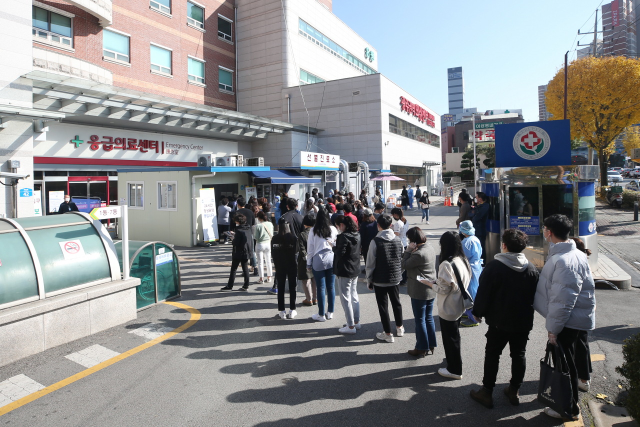 15일 오후 광주 동구 전남대병원 선별진료소에서 직원과 환자·보호자 등이 신종 코로나바이러스 감염증(코로나19) 검사를 받기 위해 줄을 서 있다. 전남대병원은 최근 소속 전공의를 비롯한 의료진과 환자·보호자가 잇따라 확진 판정을 받자 5000여명을 대상으로 전수 검사를 하고 있다. 연합뉴스