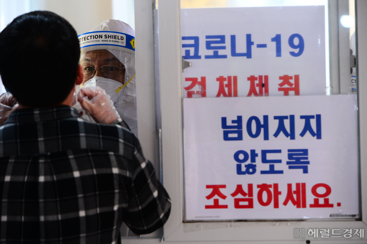 [헤럴드경제=박해묵 기자] 코로나19 확진자의 증가로 사회적 거리두기 단계를 1.5단계로 격상하기로 한 지역이 늘고 있는 가운데 18일 오전 서울 성동구보건소 코로나-19 선별진료소를 찾은 시민들이 검체채취를 하고 있다.