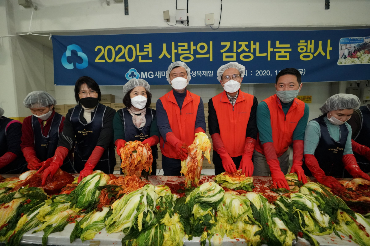 길음1동 새마을금고 김장행사에 이승로 성북구청장을 비롯한 참여자들이 김치를 담그는 모습. [성북구 제공]