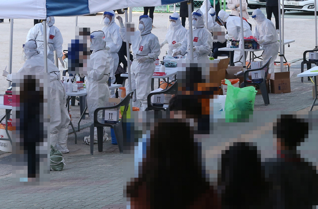 25일 신종 코로나바이러스 감염증(코로나19) 확진자가 발생한 울산시 중구 한 초등학교에서 학생과 교사를 대상으로 한 전수 검사가 이뤄지고 있다. [연합]
