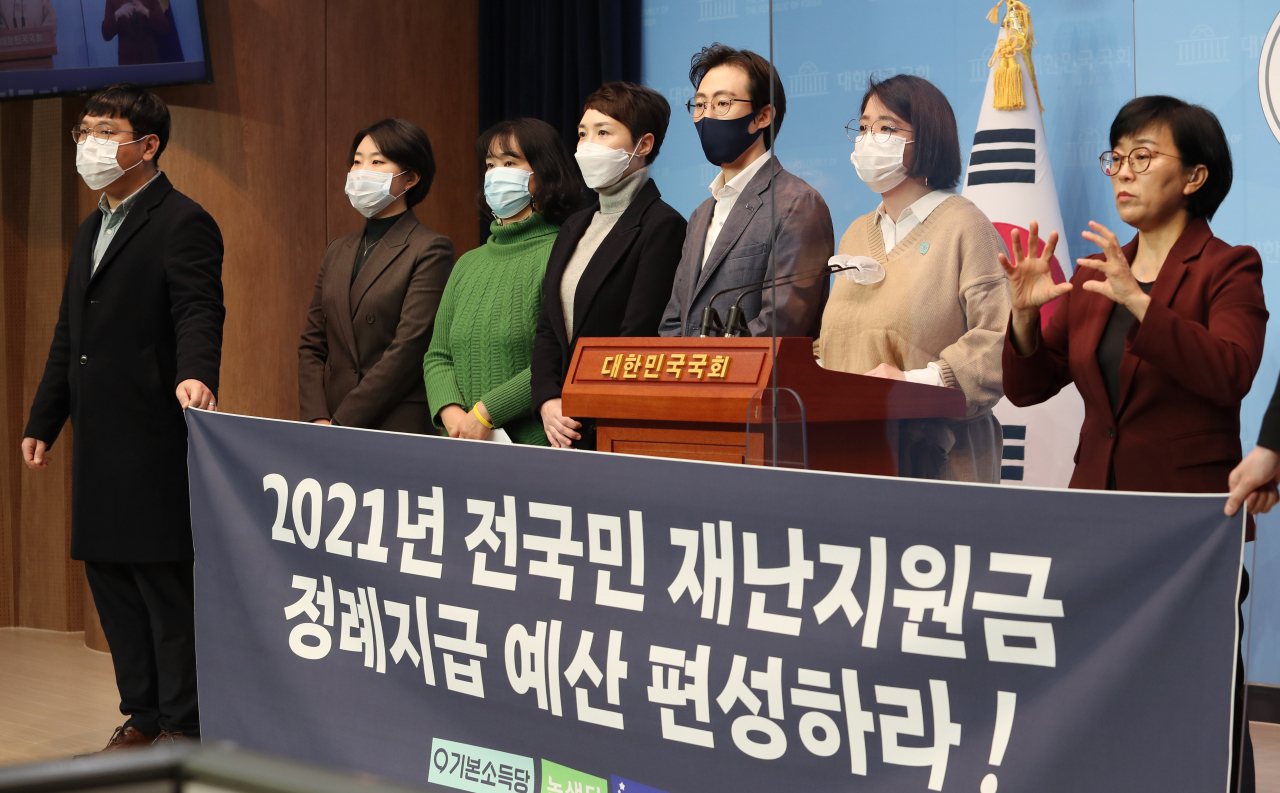 용혜인 기본소득당 의원, 녹색당, 미래당, 여성의당 당원들이 4일 국회 소통관에서 2021년 전국민 재난지원금 정례지급 예산 편성을 촉구하고 있다. [연합]