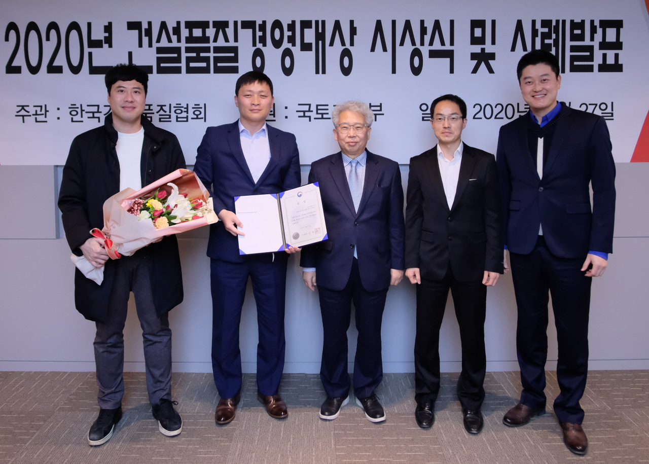 롯데건설 청량리 4구역 주택재개발 여정구 현장소장(왼쪽 두 번째) 및 기술연구원 등 행사 관계자들이 기념사진을 촬영하고 있다.[롯데건설 제공]