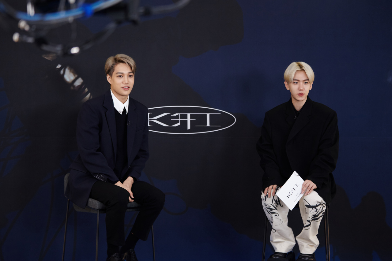 Kai (left) and Baekhyun, both members of EXO, speak during Kai’s solo debut press conference in Seoul on Monday. (S.M. Entertainment)