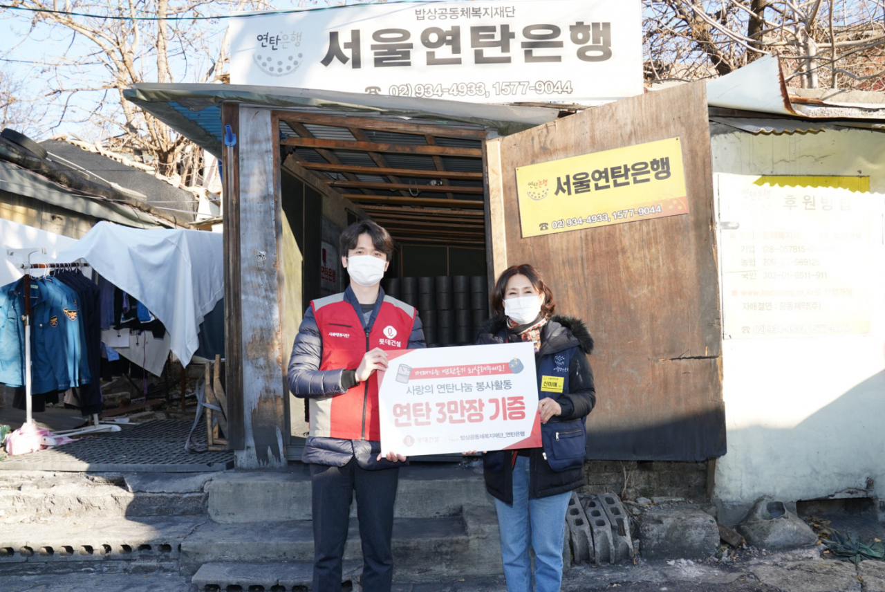 롯데건설이 겨울 취약계층을 위한 연탄을 기부한 후 서울연탄은행관계자와 기념 촬영을 하고 있다.[롯데건설 제공]