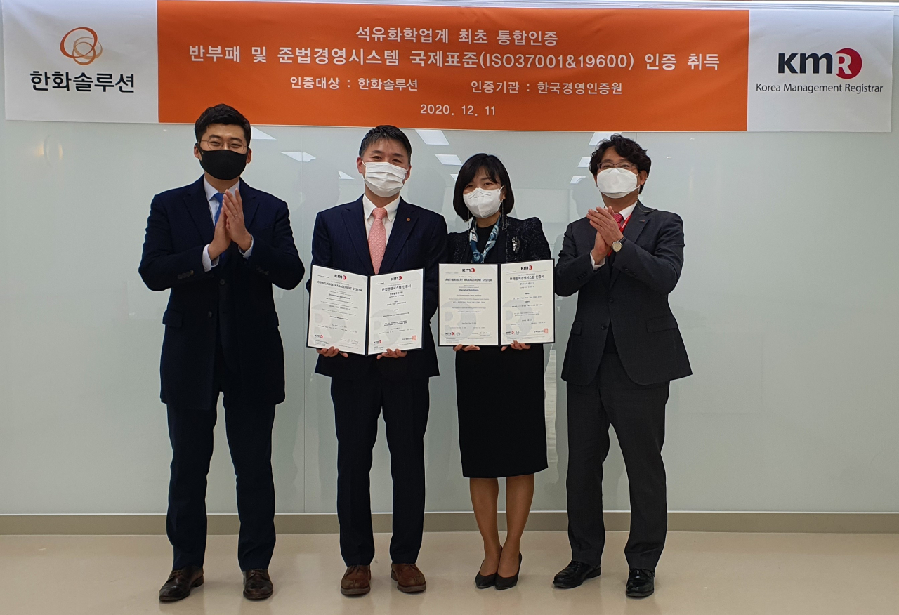 남종훈 한화솔루션 컴플라이언스실장(왼쪽 두 번째)과 황은주 한국경영인증원장(왼쪽 세 번째)이 지난 11일 서울 영등포구 한국경영인증원 본사에서 국제표준 인증 취득 기념사진을 촬영하고 있다. [한화솔루션 제공]