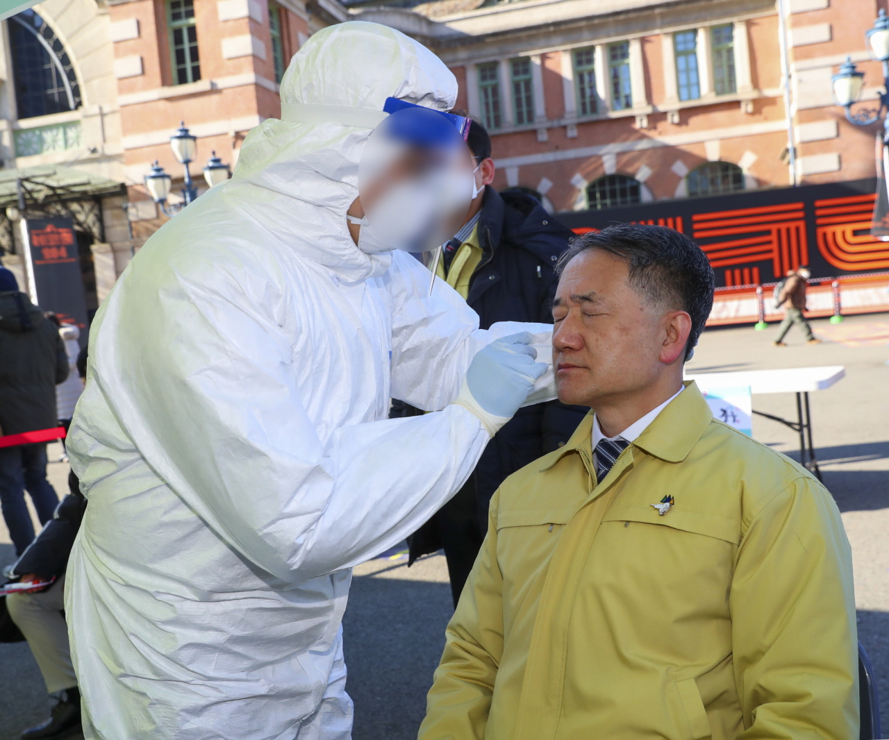 Minister of Health and Welfare Park Neung-hoo gets a nasal sample collected for a rapid antigen test, which is now being used in Korea to diagnose COVID-19, at a newly installed testing booth outside Seoul Station in the center of the city. (Ministry of Health and Welfare)