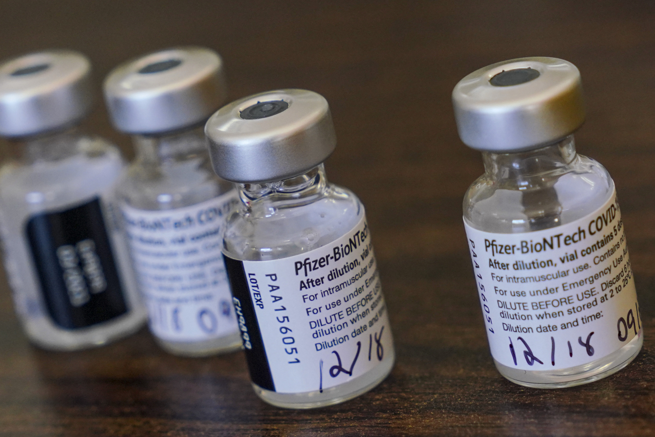 Vials of the Pfizer-BioNTech vaccine are pictured on a table as nurses prepared to vaccinate residents and staff at Gulf Shore Care Center, Friday, Dec. 18, 2020 in Pinellas Park, Fla. (Martha Asencio Rhine/Tampa Bay Times via AP) MANDATORY CREDIT