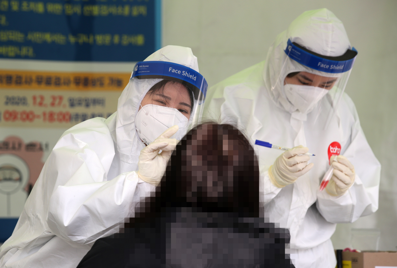 29일 오전 광주광역시 시청광장에 설치된 코로나19 임시 선별검사소에서 한 시민이 신종 코로나바이러스 감염증 검사를 받고 있다. [연합]