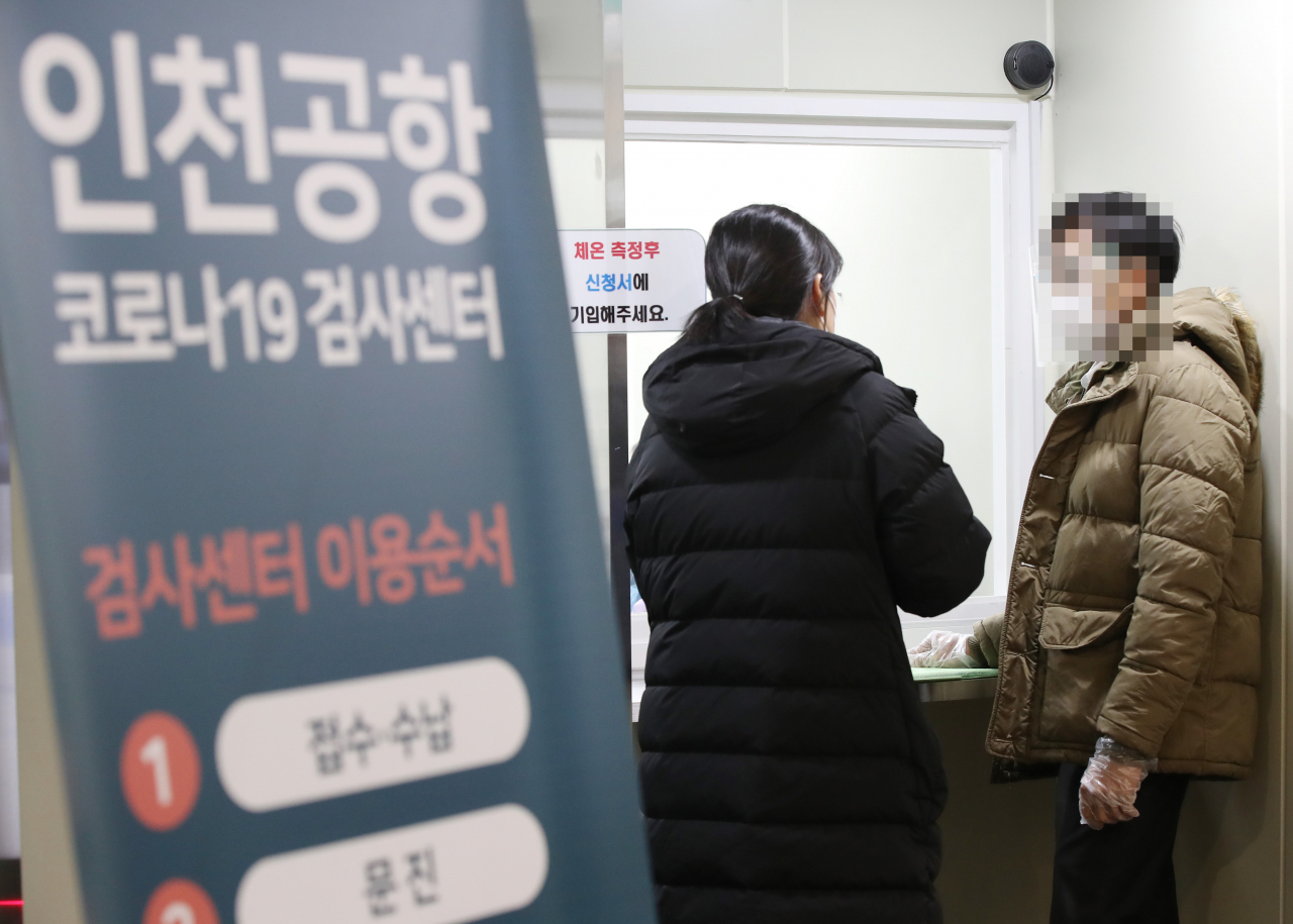 인천공항 코로나19 검사센터 운영이 시작된 31일 인천국제공항 제2 터미널에 마련된 검사센터에서 한 외국인이 관계자와 상담하고 있다. [연합]