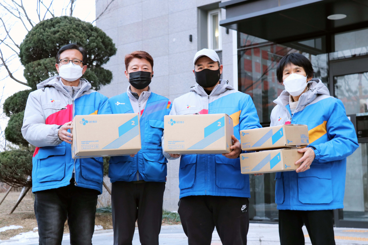 CJ대한통운 블루택배 배송원들이 아파트 단지내에서 기념사진을 찍고 있다. [CJ대한통운 제공]