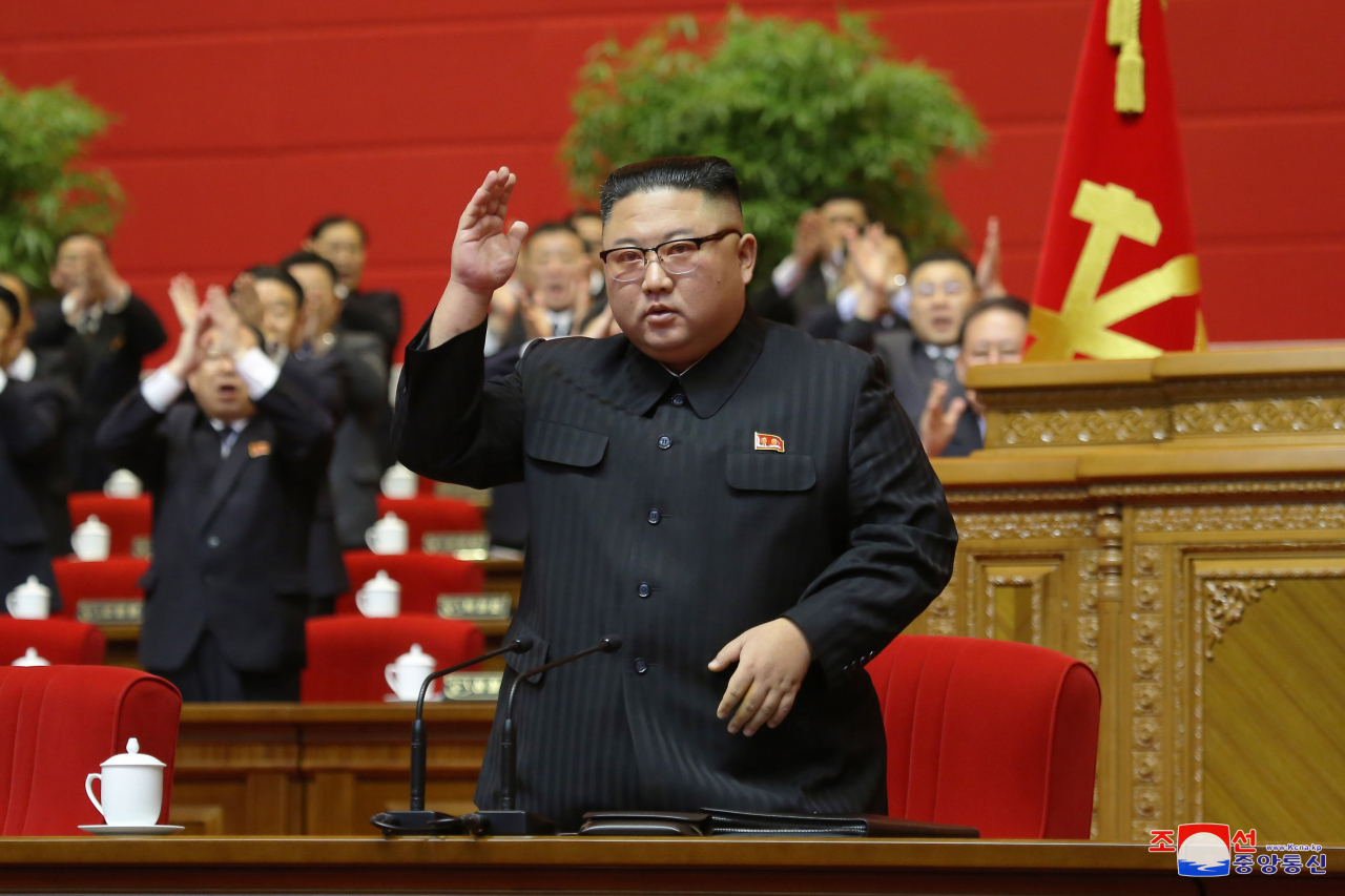 North Korean leader Kim Jong-un waves to officials attending the final day of the eighth congress of the ruling Workers' Party in Pyongyang on Tuesday. (KCNA-Yonhap)
