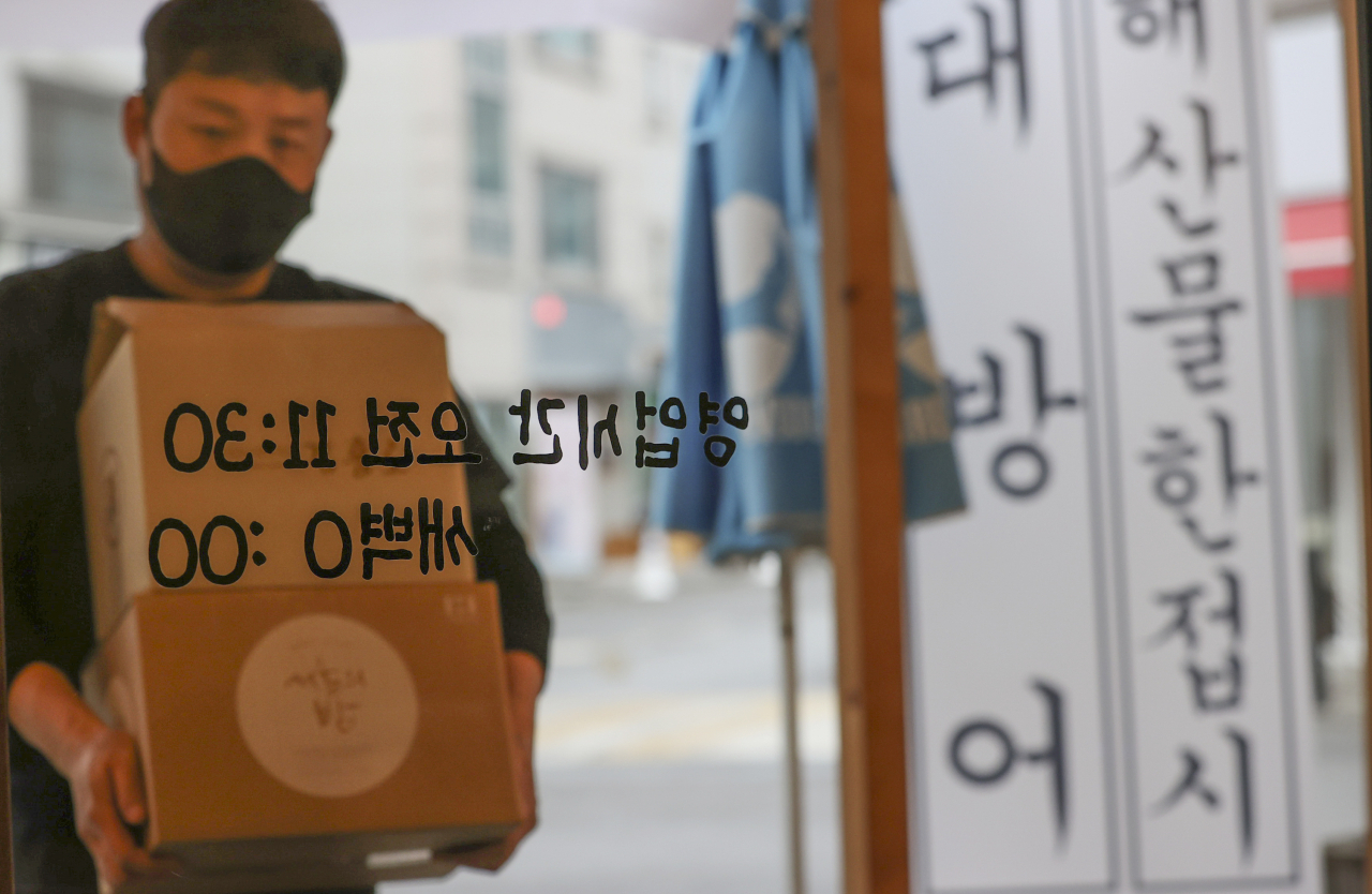 정부는 16일 수도권 2.5단계, 전국 2단계인 현 거리두기 단계를 2주 더 연장하고 개인간 감염 확산을 억제하는데 효과가 컸던 ‘5인 이상 모임 금지’와 ‘21시 이후 영업제한’ 조치도 계속 시행하기로 했다. 지난 15일 오후 서울 용산구 한 음식점에서 관계자가 영업 준비를 하고 있다. [연합]