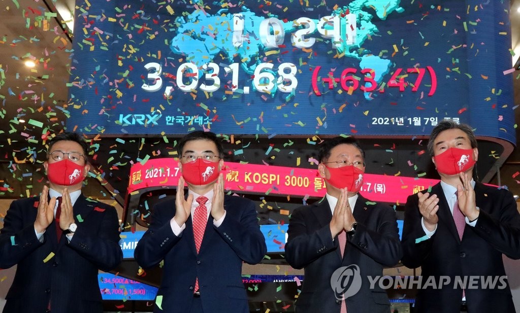 Officials at Korea Exchange celebrate during a ceremony to mark the benchmark Korea Composite Stock Price Index's (KOSPI) breakthrough of the 3,000-point mark for the first time in its history on Jan. 7, 2021, when the index soared 63.47 points, or 2.14 percent, to close at 3,031.68 points.