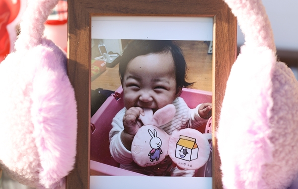 경기도 양평 하이패밀리 안데르센 공원묘지에 안장된 정인양의 묘지에 귀마개로 감싸진 정인양 사진이 놓여있는 모습. [연합]